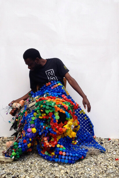 Moffat Takadiwa with his work, Copyright the artist, Courtesy Tyburn Gallery