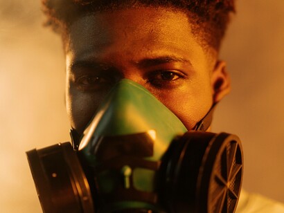 A recent climate disaster has forced this man to wear a protective gas mask