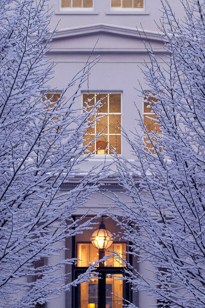 Coworth Park, entrance with snowy trees - evening