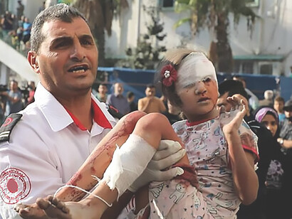 Compassionate medic transporting injured Palestinian child in Gaza crisis