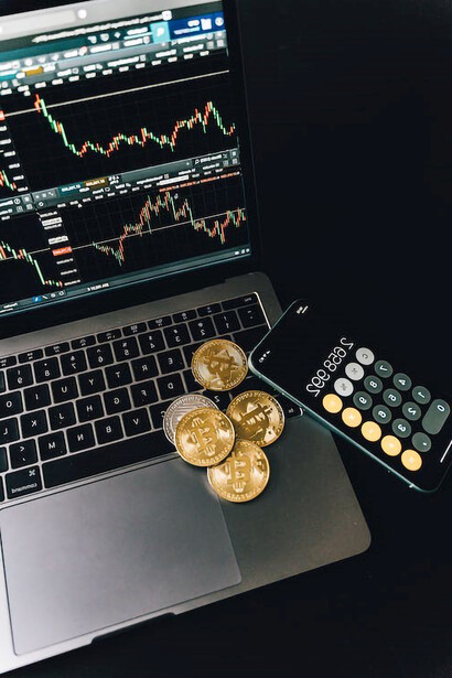 On the table sat a computer, displaying bitcoins on its screen, alongside a calculator—a setup suggesting someone was deeply engaged in the act of investing