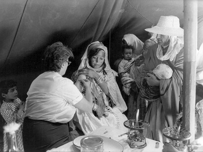 A women is getting treatment by a nurse during the Algerian War, 1962