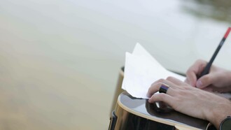 Writing a poem by the river