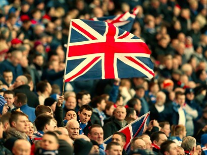 The Union Jack flag waving in a sea of British people who are resorting to nationalism