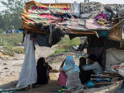 Rohingya people sitting outside at their Camp house