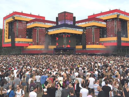 A large crowd gathered in front of the main stage at the Glastonbury Festival in England, celebrating music and community