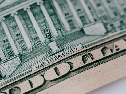A dollar bank note on a white table
