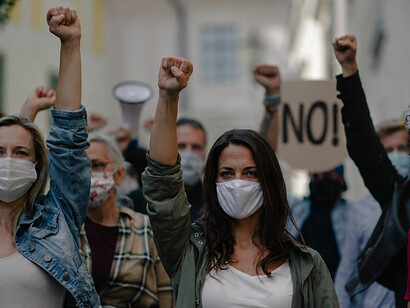 A group of activists participating in a street protest and women's rights demonstration
