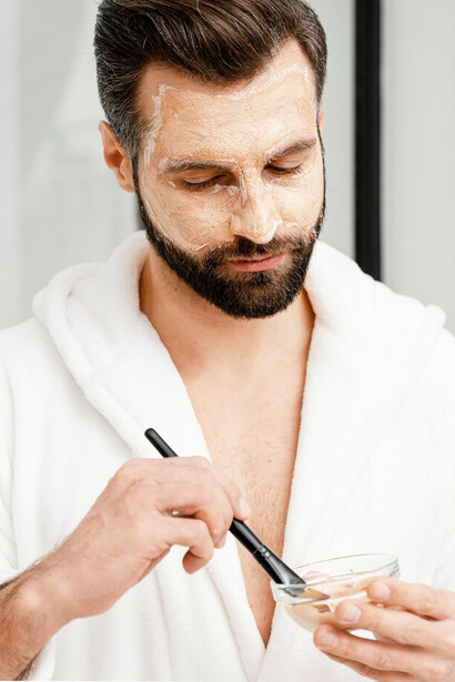 Men using self-care products, focusing on skincare routines, and embracing beauty trends popularized on social media