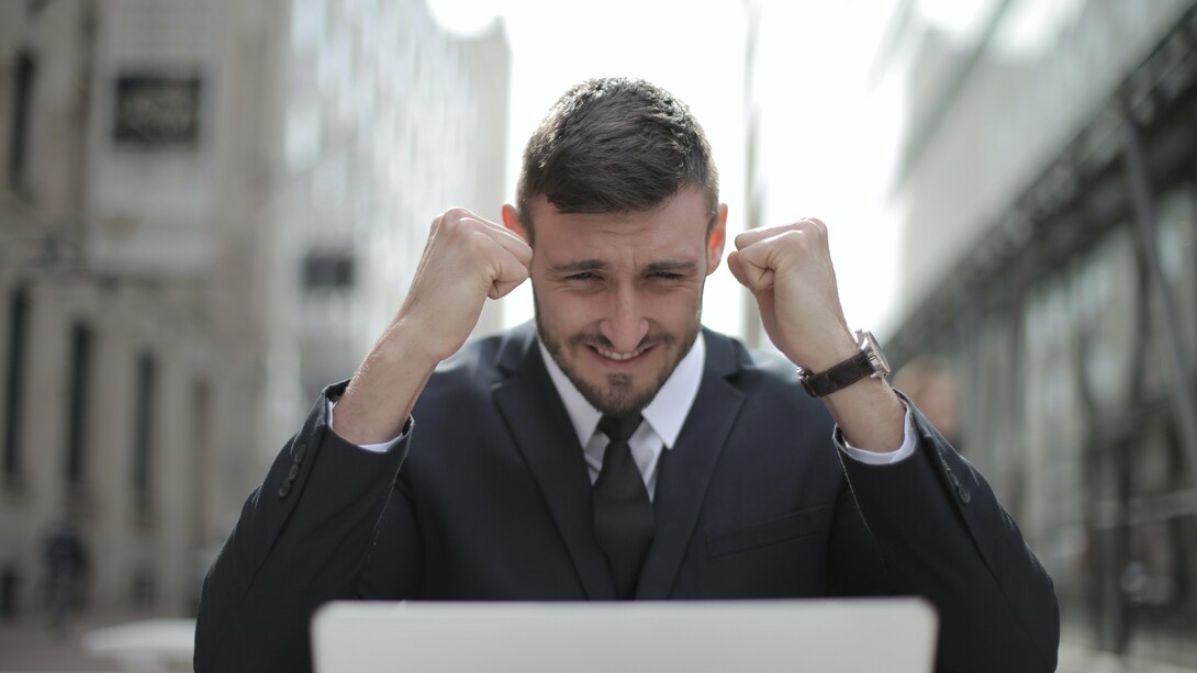 Man in suit celebrating success