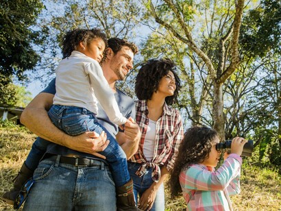 A family surrounded by greenery and light, reflecting the peace found in shared experiences