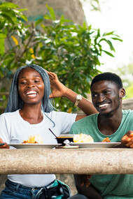 Friends share stories and smiles as they dig into a hearty meal of fufu, turning a simple gathering into a celebration of culture and connection