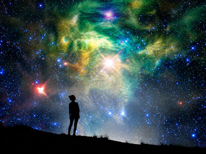 Silhouette of a woman outside under a glowing starry background