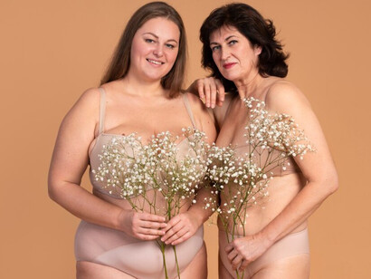 A medium shot of smiling women of different ages holding flowers, symbolizing the premenopause transition