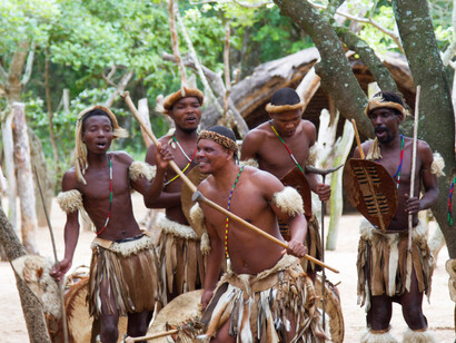 The vibrant colours of their cowhide and shields contrast beautifully with the joyful expressions of the dancers, illustrating the deep-rooted pride in isiZulu and its cultural significance