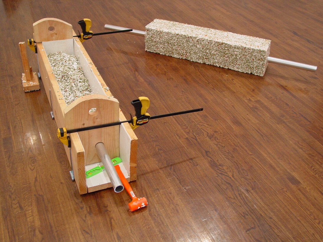 Left: Prototype Kebab Mold, 2002, Wood, Perfect World aluminum pipe skewer, PeaRoeFoam (dried peas, salmon roe, Styrofoam beads, glue), latex paint, and twine, 18 1/2 x 74 x 13 inches (47 x 188 x 33 cm). Right:
PeaRoeFoam Prototype Kebab, 2002, Perfect World aluminum pipe skewer and PeaRoeFoam (dried peas, salmon roe, Styrofoam beads, glue), 8 1/2 x 74 x 9 inches (21.6 x 188 x 22.9 cm)