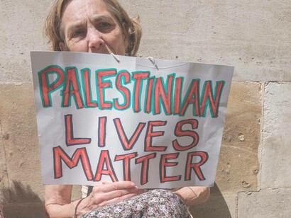 A sign reading 'Palestinian Lives Matter" held by someone who understands the toll of displacement