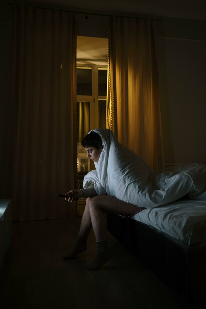 A person sitting alone in the dark 
