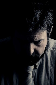 In the depths of darkness, a sorrowful man battles complex emotions, confronting depression and tough choices