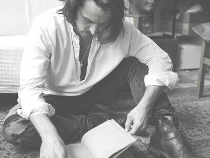 A poet drawing inspiration from written words of the past