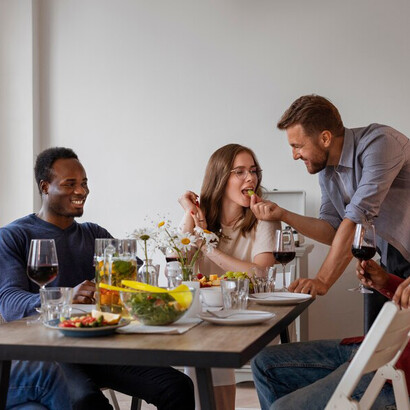Friends enjoy a lively dinner party over glasses of wine in the heart of India