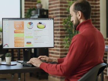 A data analyst reviewing performance metrics and audience trends, representing the growing role of analytics in entertainment decision-making