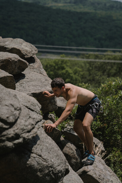 A man climbs up the rocks to get to the top, with the confidence he needs to do it
