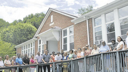 Previous students and teachers celebrate a school reunion and stand in front of what was once Carnegie High School in Marion, Virginia, USA. This school was an important site for the Black community in Smyth County