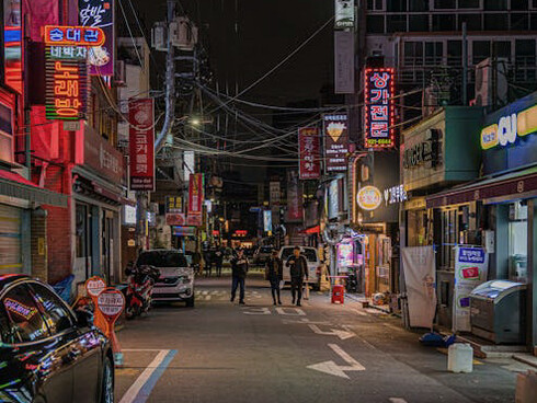 The vibrant streets of Seoul, South Korea, come alive at night with colourful lights and the constant flow of people, showcasing the city's perfect blend of tradition and innovation