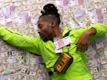 A man lays content on top of all of his cash