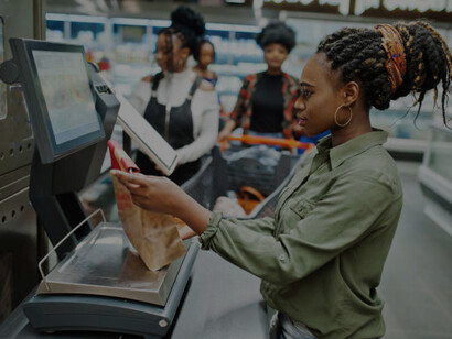 A woman selects groceries in a cashierless store that relies on automated checkout systems