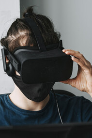 A man in a virtual reality helmet, isolated from the world