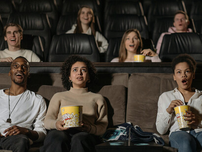 Audience members seated in a movie theater during a film screening