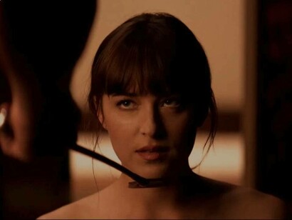 Anastasia Steele is on her knees in the movie "50 Shades of Grey" waiting to receive the next sexual orders from Christian Grey