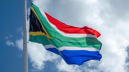 South African flag waves in the sky