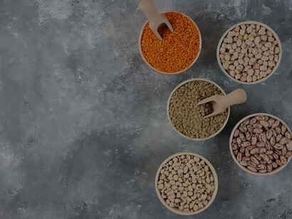 Various raw dals elegantly arranged on a marble tabletop, showcasing a diverse composition of dals
