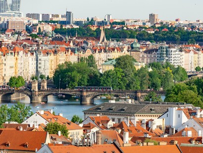 Prague’s historic buildings and red-tiled roofs stretching across the cityscape, reflecting its celebrated European charm