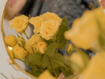 The reflection of a bunch of vibrant yellow flowers