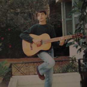 Young Yasser Mroué playing the guitar. From Rabih Mroué, Riding on a Cloud, 2013.