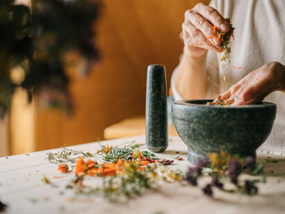 A moment of mindful preparation, blending herbs for healing and balance
