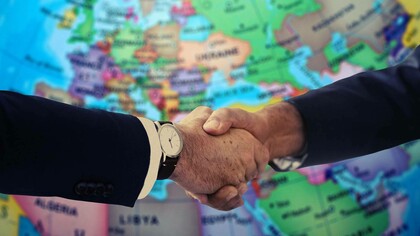 Two diplomats shaking hands in the spirit of global and dynamic diplomacy for the sake of sustainable peace