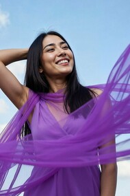 A woman at ease as fabric moves with the wind, symbolizing the freedom of becoming emotionally whole