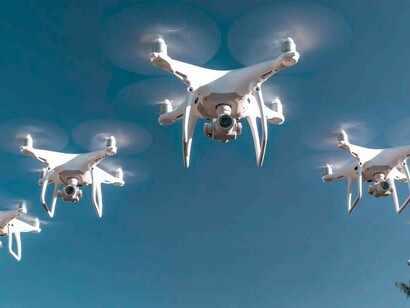 Drones hovering over a practice target in a military exercise