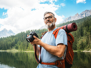 Elderly man hiking in the mountains, demonstrating vitality, endurance, and a passion for outdoor exploration