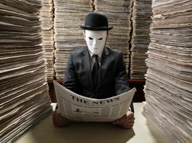 A man reads a newspaper in order to censor it