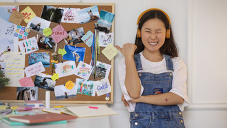 A woman creates a vision board using curated lifestyle images for visual inspiration