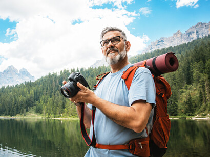 Elderly man hiking in the mountains, demonstrating vitality, endurance, and a passion for outdoor exploration
