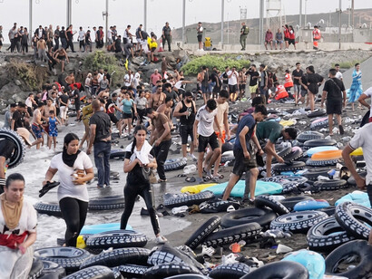 An estimated 60,000 people crossed from Morocco into the Spanish enclave of Ceuta, overwhelming the city as border authorities responded with water cannons, tear gas, and warning shots