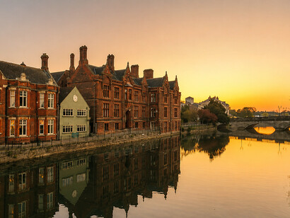 Early morning sunlight rising over the River Great Ouse in Bedford, United Kingdom, illuminating the peaceful river and surrounding architecture