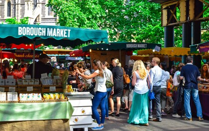 Local vendors welcoming visitors at Borough Market in London, presenting the city's commitment to preserving its culinary traditions